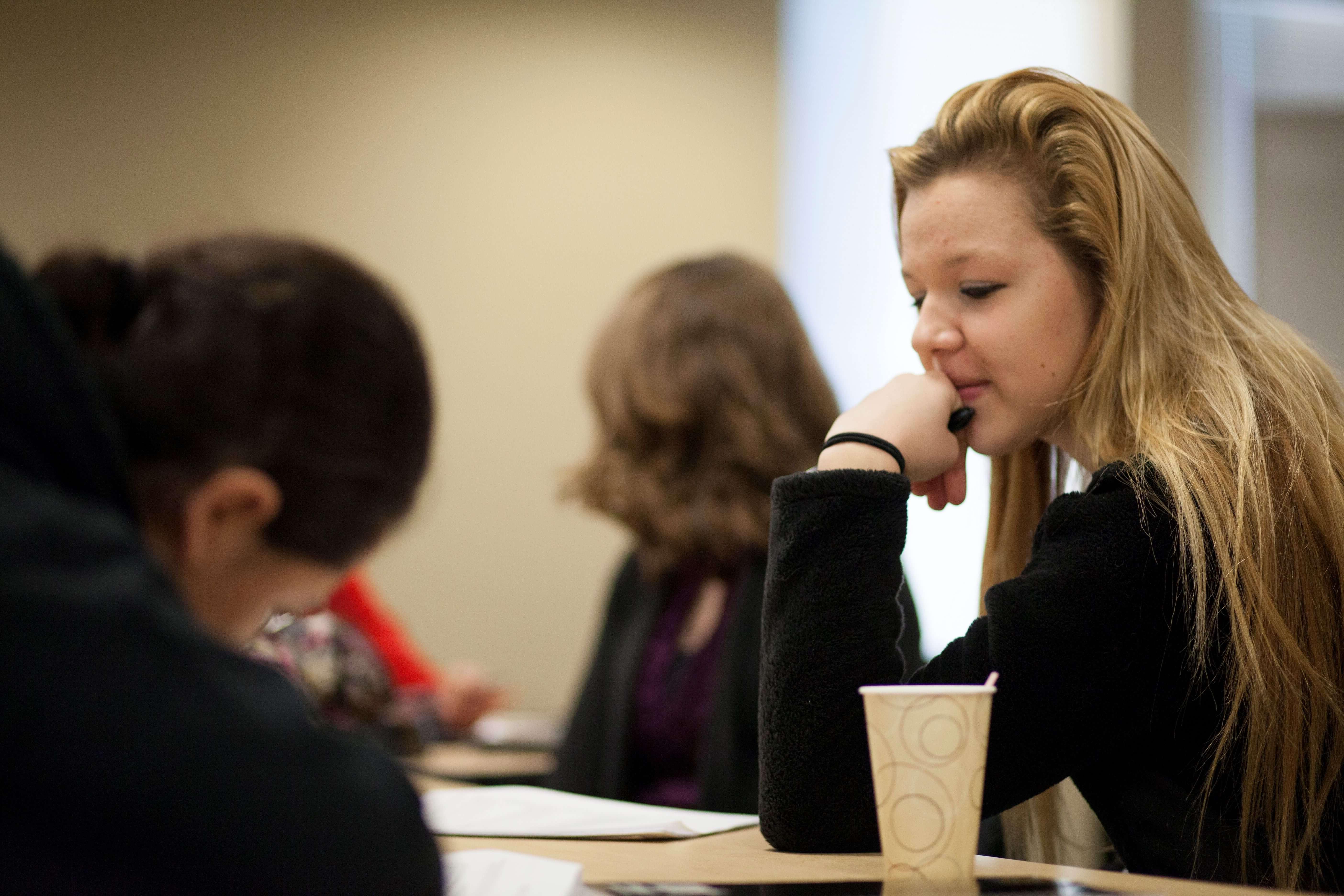 Female student with chin on her hand